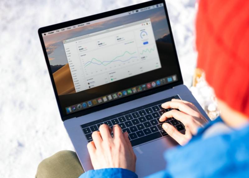 Someone working on a laptop showing an operations dashboard