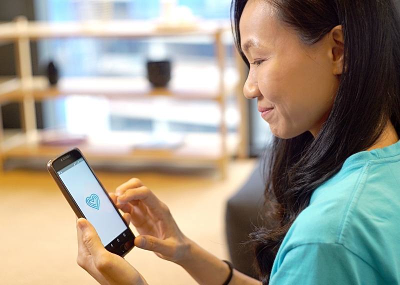 A care worker checking her visit schedule on the mobile app