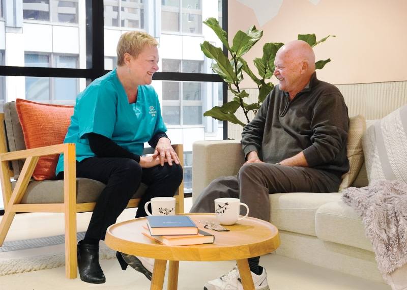 A care manager talking with an older client in a living room